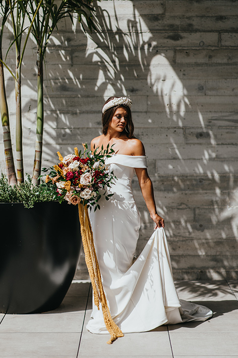  modern and colorful wedding with the bride in an off-the-shoulder dress and the groom in an all-black tuxedo - bride 