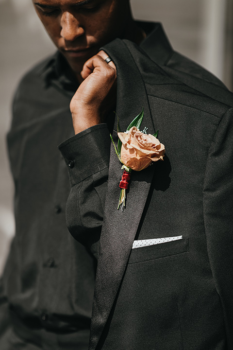  modern and colorful wedding with the bride in an off-the-shoulder dress and the groom in an all-black tuxedo – groom 