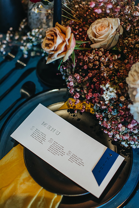  modern and colorful wedding with the bride in an off-the-shoulder dress and the groom in an all-black tuxedo – reception table décor