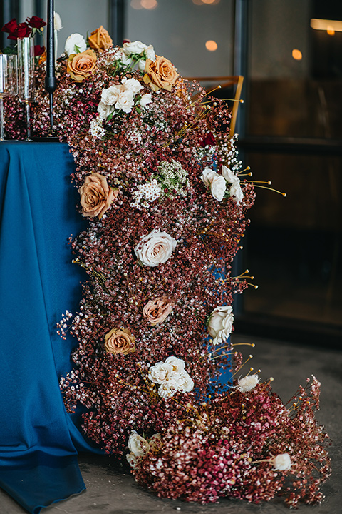  modern and colorful wedding with the bride in an off-the-shoulder dress and the groom in an all-black tuxedo – reception table décor 