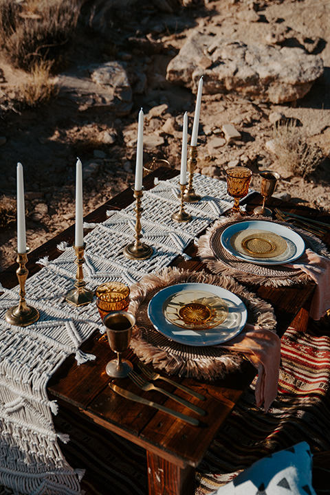  a boho wedding at lake powell with the bride in a bohemian gown and a wide brimmed hat and the groom in a gold velvet jacket – reception décor 