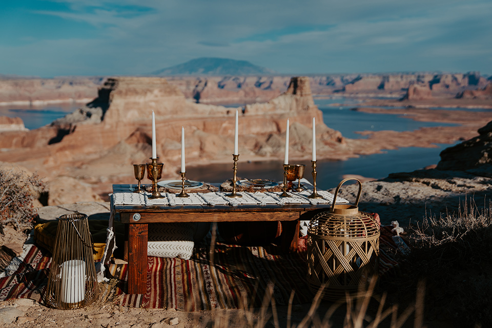  a boho wedding at lake powell with the bride in a bohemian gown and a wide brimmed hat and the groom in a gold velvet jacket – reception space